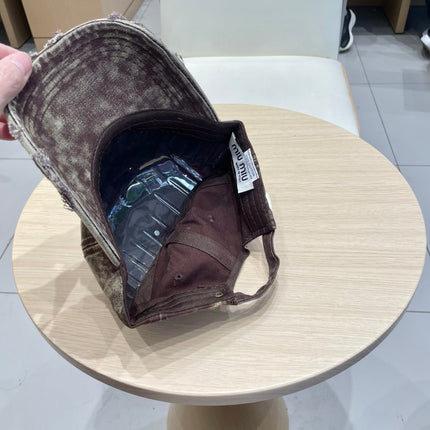 MIUMIU DISTRESSED FABRIC BASEBALL CAP IN BROWN WITH EMBROIDERED LOGO