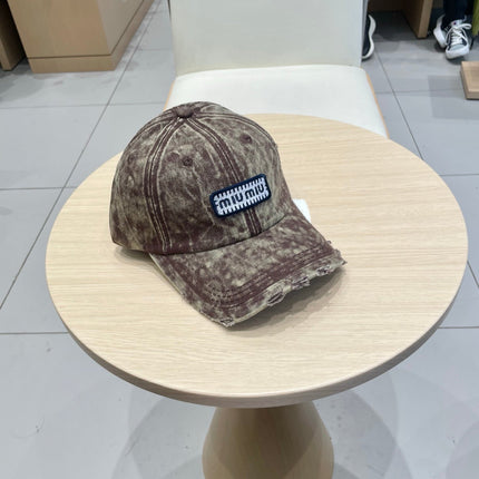 MIUMIU DISTRESSED FABRIC BASEBALL CAP IN BROWN WITH EMBROIDERED LOGO