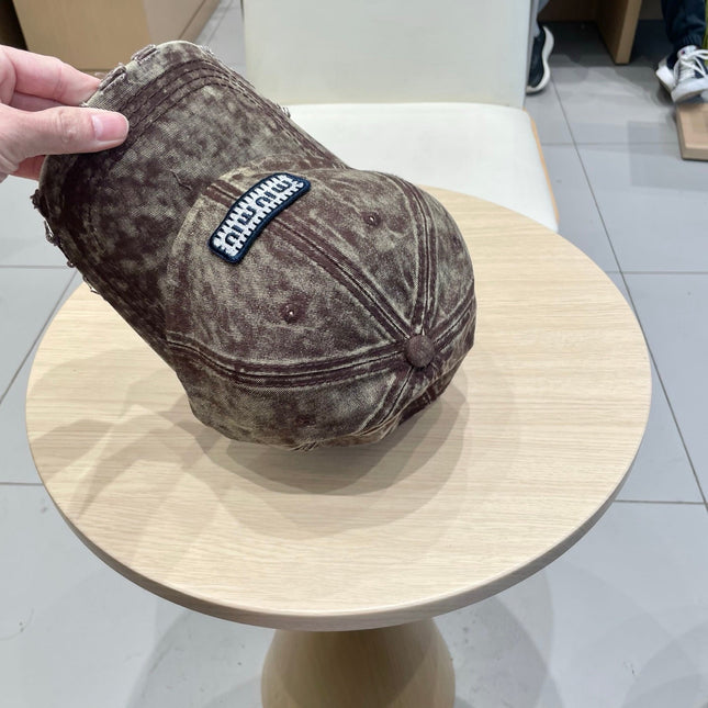 MIUMIU DISTRESSED FABRIC BASEBALL CAP IN BROWN WITH EMBROIDERED LOGO
