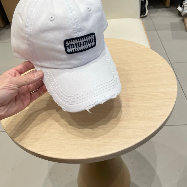 MIUMIU DISTRESSED FABRIC BASEBALL CAP IN WHITE WITH EMBROIDERED LOGO