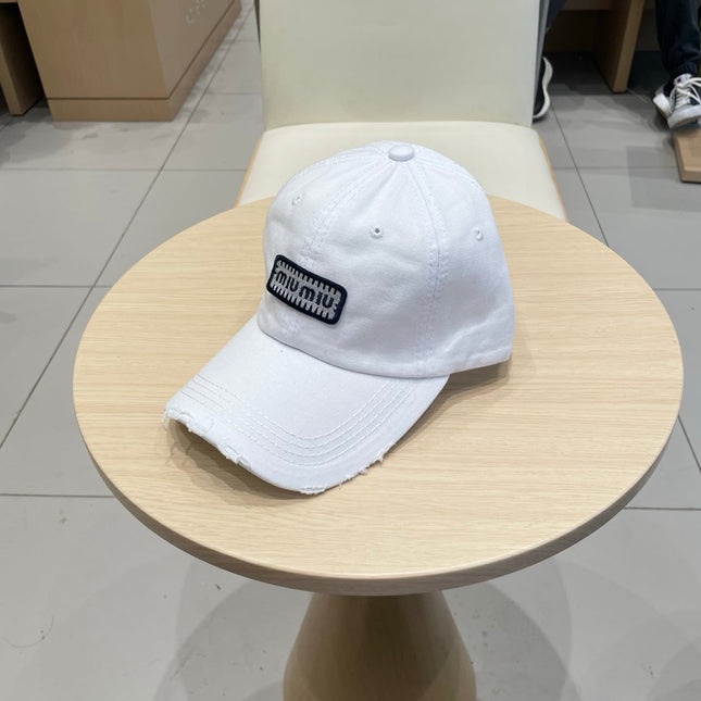 MIUMIU DISTRESSED FABRIC BASEBALL CAP IN WHITE WITH EMBROIDERED LOGO