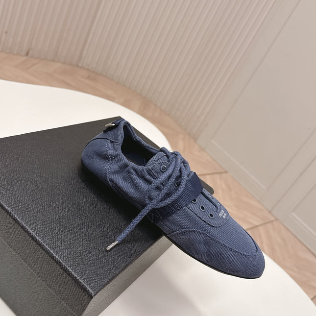 PRADA 26S LACE UP MINIMAL SNEAKERS IN NAVY BLUE CANVAS