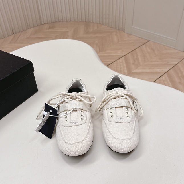 PRADA 26S LACE UP MINIMAL SNEAKERS IN WHITE CANVAS