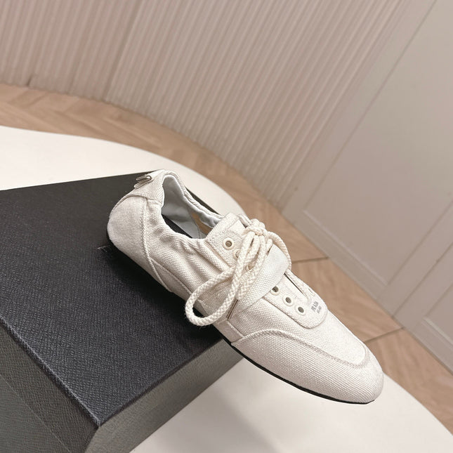 PRADA 26S LACE UP MINIMAL SNEAKERS IN WHITE CANVAS