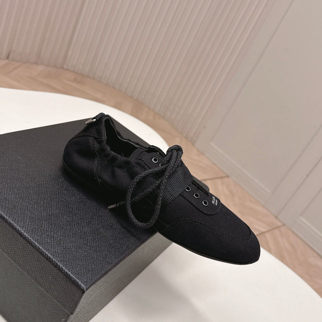 PRADA 26S LACE UP MINIMAL SNEAKERS IN BLACK CANVAS