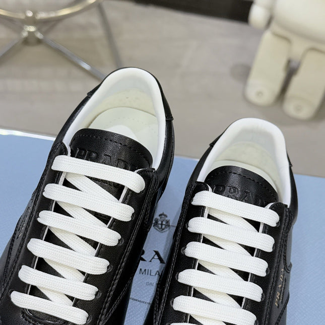 PRADA 26S LACE UP SNEAKERS IN BLACK CALFSKIN