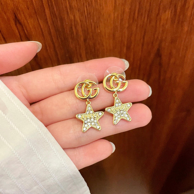 GUCCI 26S DOUBLE G STAR CRYSTAL DROP EARRINGS IN GOLD TONE METAL 627015