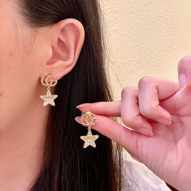 GUCCI 26S DOUBLE G STAR CRYSTAL DROP EARRINGS IN GOLD TONE METAL 627015