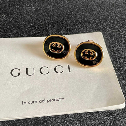 GUCCI 26S INTERLOCKING G ROUND LOGO STUD EARRINGS IN BLACK ENAMEL & GOLD TONE METAL 625716