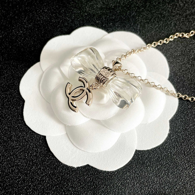 CHANEL 26S DOUBLE C LOGO CLEAR BOW PENDANT NECKLACE IN GOLD METAL 629174