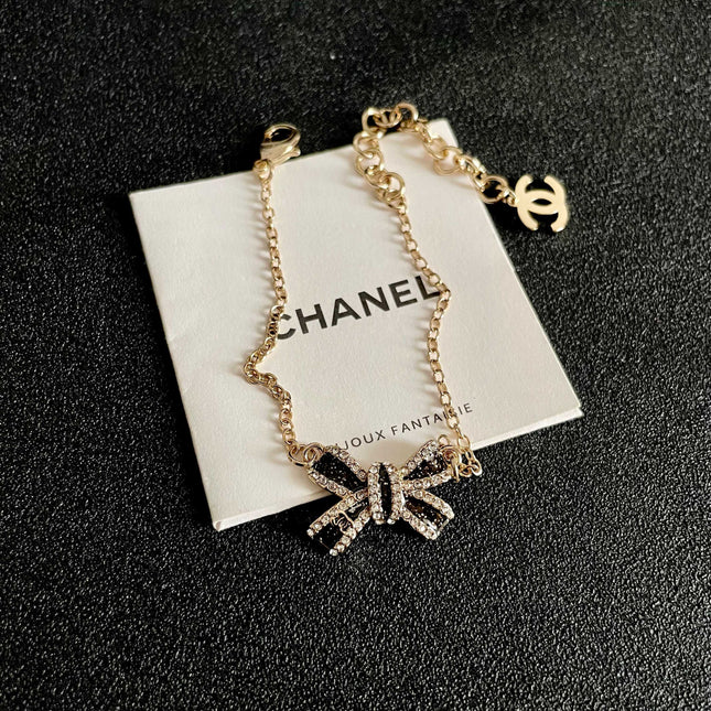 CHANEL 26S CRYSTAL BOW CHAIN BRACELET IN GOLD METAL 629980