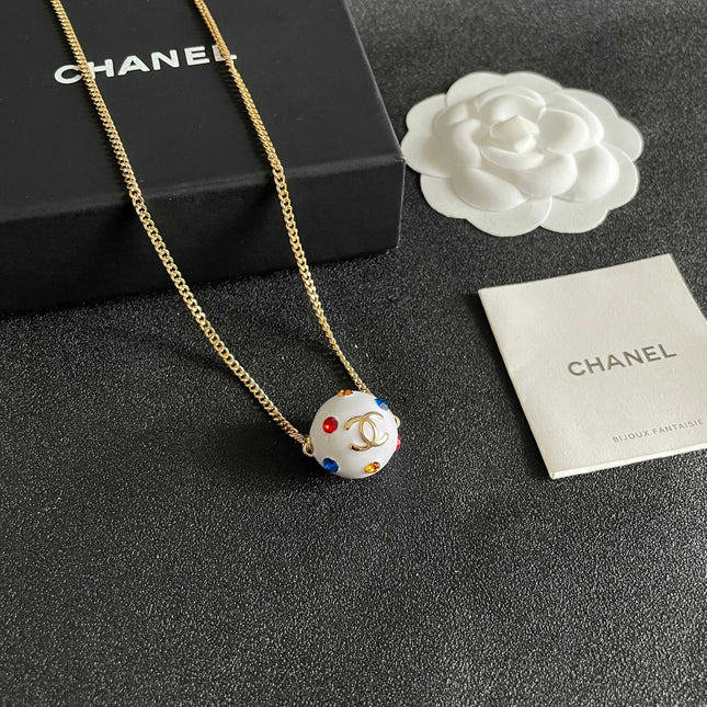 CHANEL 26S DOUBLE C LOGO WHITE ENAMEL CRYSTAL BALL PENDANT NECKLACE IN GOLD METAL 629889