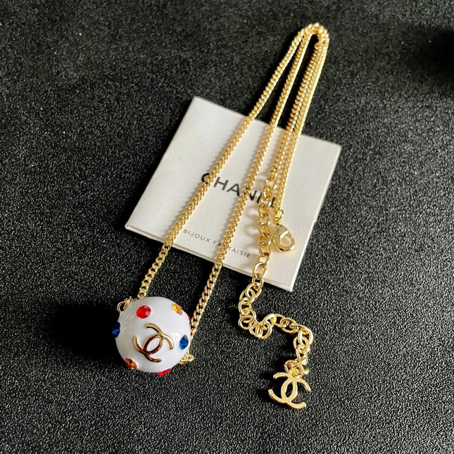 CHANEL 26S DOUBLE C LOGO WHITE ENAMEL CRYSTAL BALL PENDANT NECKLACE IN GOLD METAL 629889