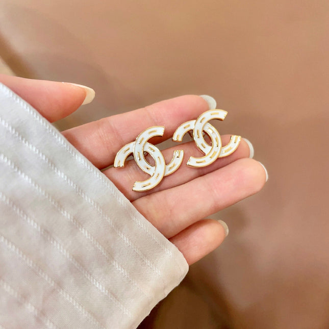 CHANEL 26S DOUBLE C LOGO WHITE ENAMEL STUD EARRINGS IN GOLD METAL 629903