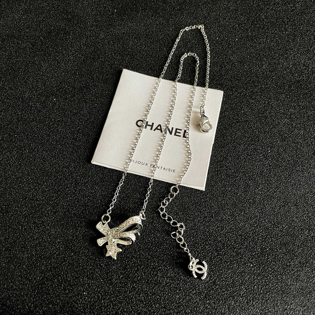 CHANEL 26S DOUBLE C LOGO CRYSTAL BOW & STAR PENDANT NECKLACE IN SILVER METAL 631019