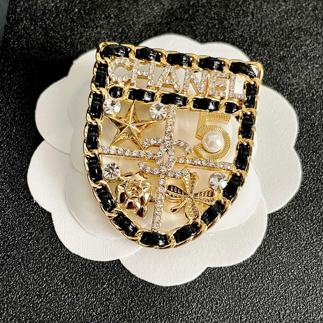 CHANEL 26S NUMBER SHIELD BROOCH WITH MULTI-CRYSTAL DETAIL IN GOLD METAL 631042