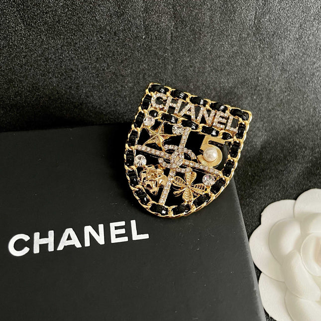 CHANEL 26S NUMBER SHIELD BROOCH WITH MULTI-CRYSTAL DETAIL IN GOLD METAL 631042