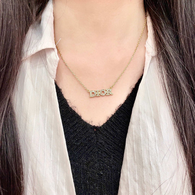 CD 26S PAVE LOGO LETTER NECKLACE IN GOLD TONE METAL 631806