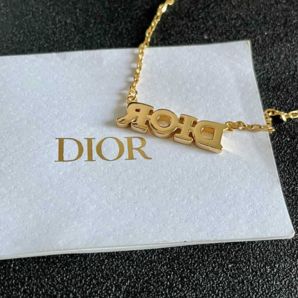 CD 26S PAVE LOGO LETTER NECKLACE IN GOLD TONE METAL 631806