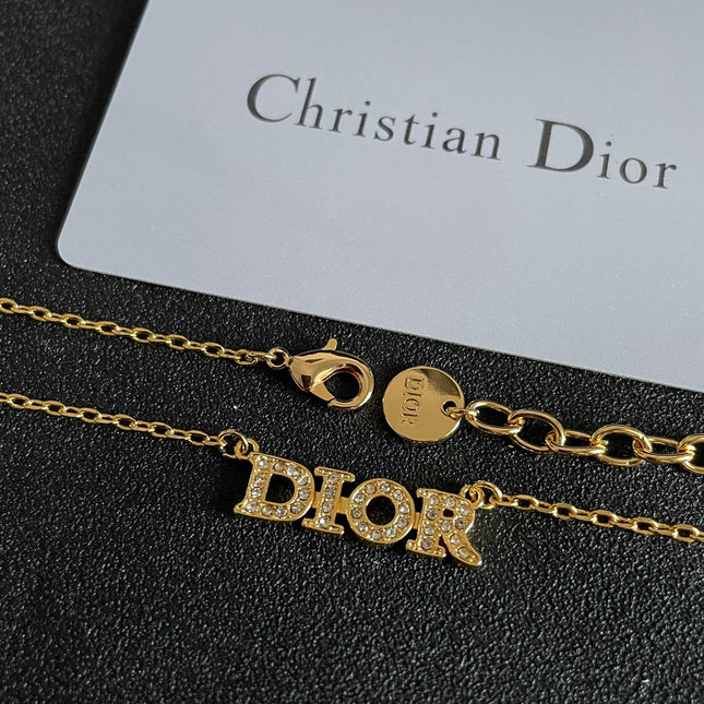 CD 26S PAVE LOGO LETTER NECKLACE IN GOLD TONE METAL 631806