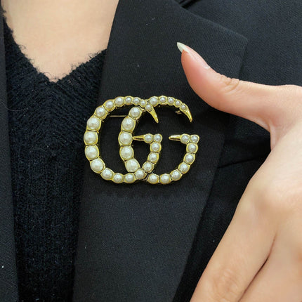 GUCCI 26S DOUBLE G LOGO PEARL EMBELLISHED STATEMENT BROOCH IN GOLD TONE METAL 631921