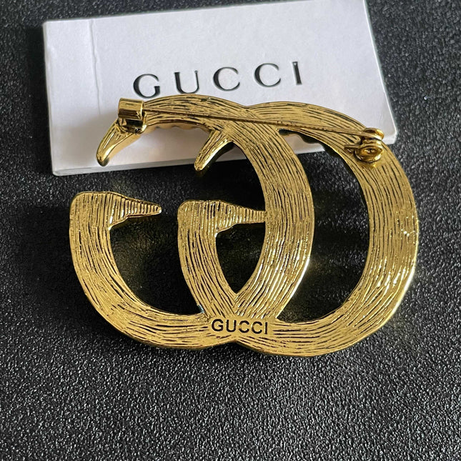 GUCCI 26S DOUBLE G LOGO PEARL EMBELLISHED STATEMENT BROOCH IN GOLD TONE METAL 631921