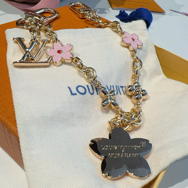 SAKURA BAG CHARM IN GOLD METAL HARDWARE