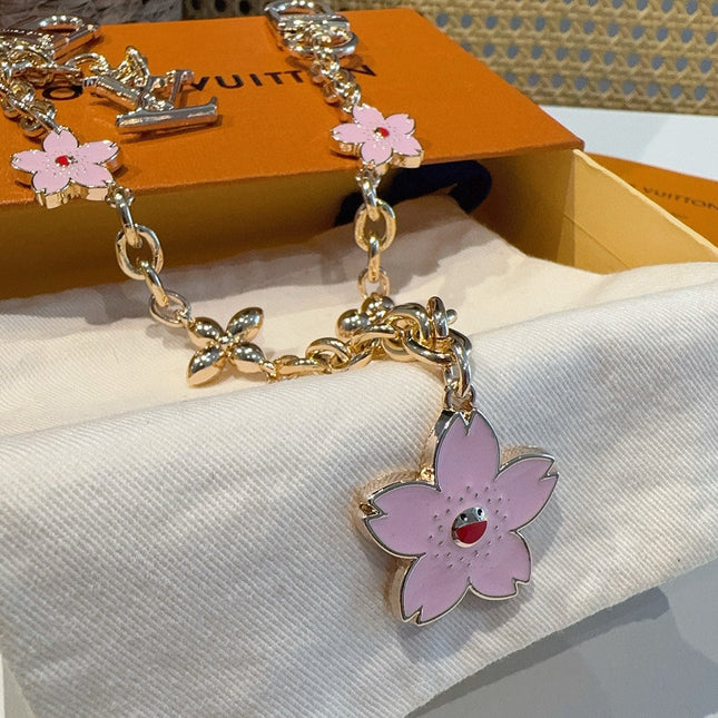 SAKURA BAG CHARM IN GOLD METAL HARDWARE