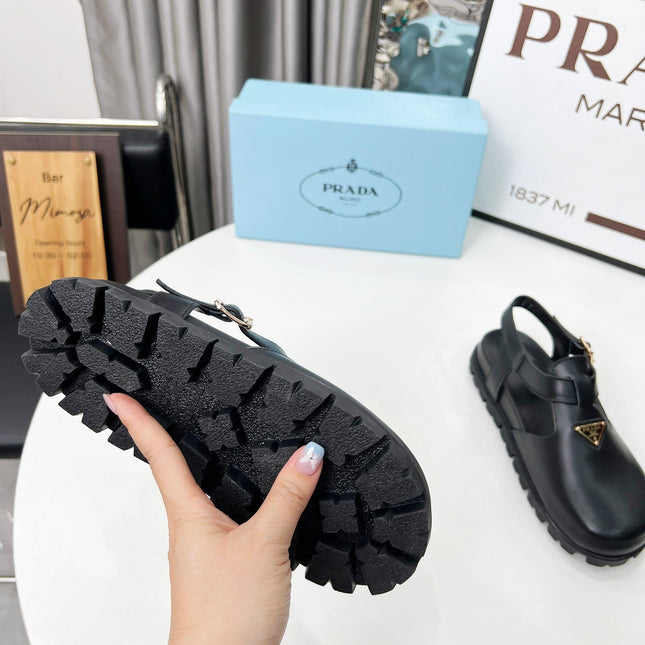 PRADA 26S RUBBER LOGO CHUNKY SOLE FISHERMAN SANDALS IN BLACK CALFSKIN