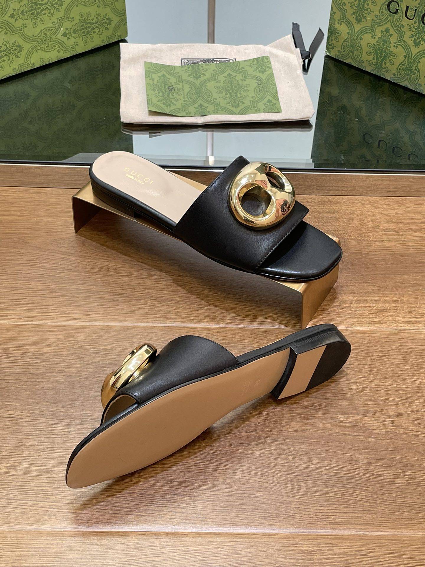 FLAT MULE IN BLACK CALFSKIN WITH GOLD HARDWARE