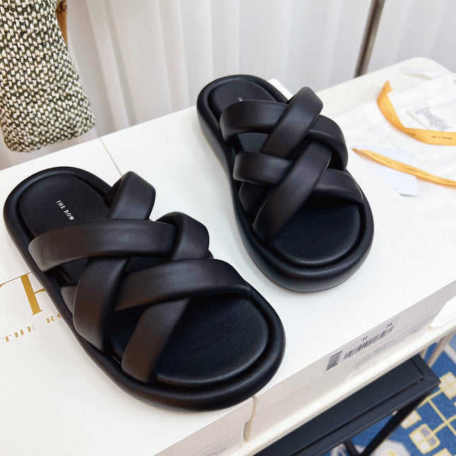 THE ROW 26S CROSSED PADDED SLIDES IN BLACK CALFSKIN