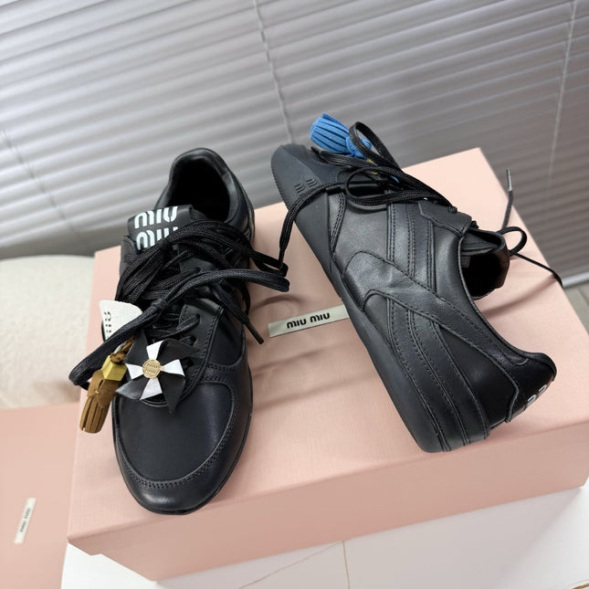 MIUMIU 26S GYMNASIUM SNEAKER IN BLACK CALFSKIN WITH GOLD BUCKLED STRAP