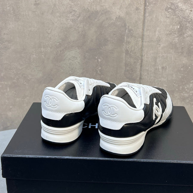 CHANEL 26S SNEAKERS IN BLACK AND WHITE QUILTED CALFSKIN CC LOGO