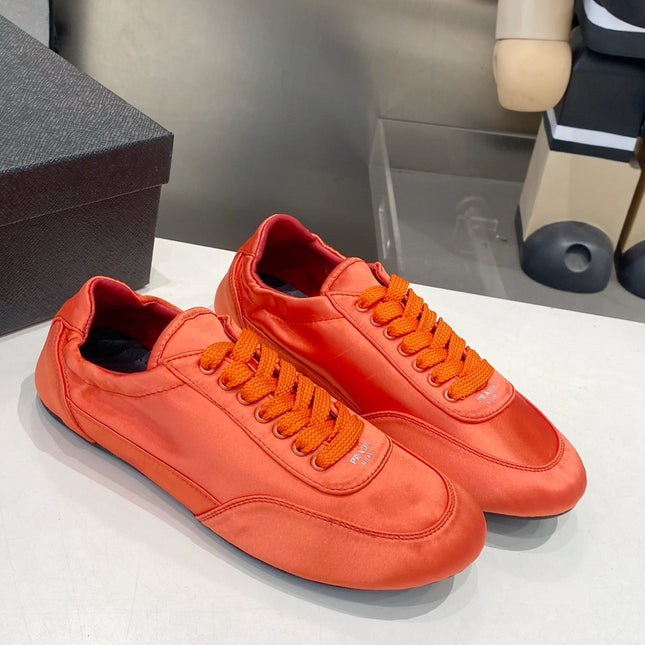 PRADA 26S SNEAKERS IN BURNT ORANGE SATIN