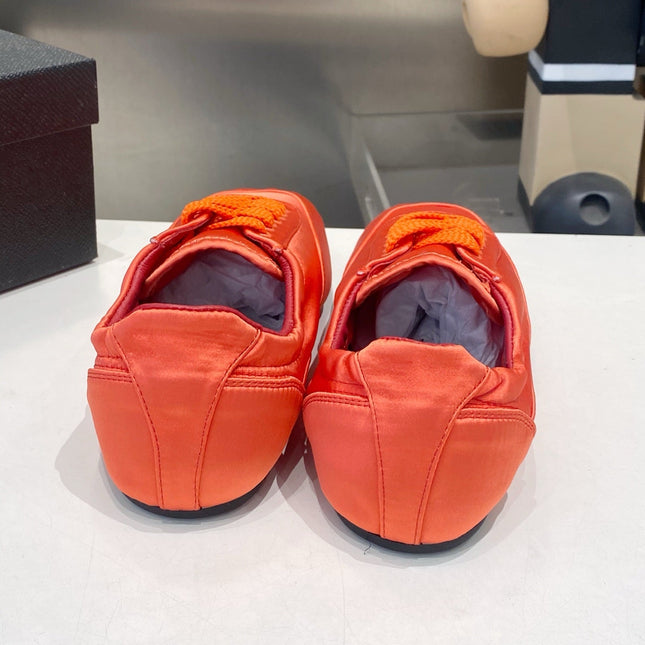 PRADA 26S SNEAKERS IN BURNT ORANGE SATIN