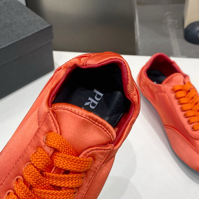 PRADA 26S SNEAKERS IN BURNT ORANGE SATIN