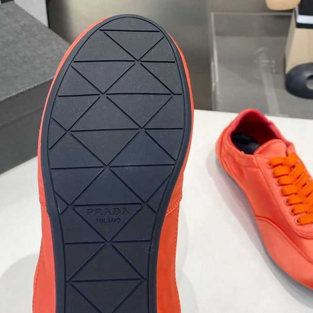 PRADA 26S SNEAKERS IN BURNT ORANGE SATIN