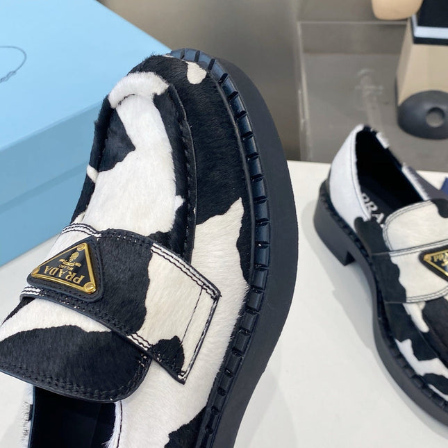 PRADA 26S LOAFERS IN WHITE AND BLACK COW PRINT PONY HAIR