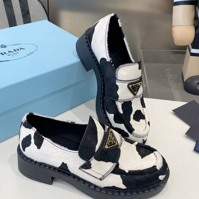 PRADA 26S LOAFERS IN WHITE AND BLACK COW PRINT PONY HAIR
