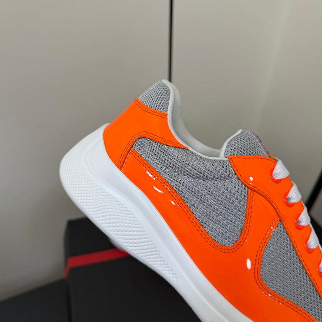 PRADA 26S SNEAKERS IN ORANGE PATENT CALFSKIN AND WHITE MESH