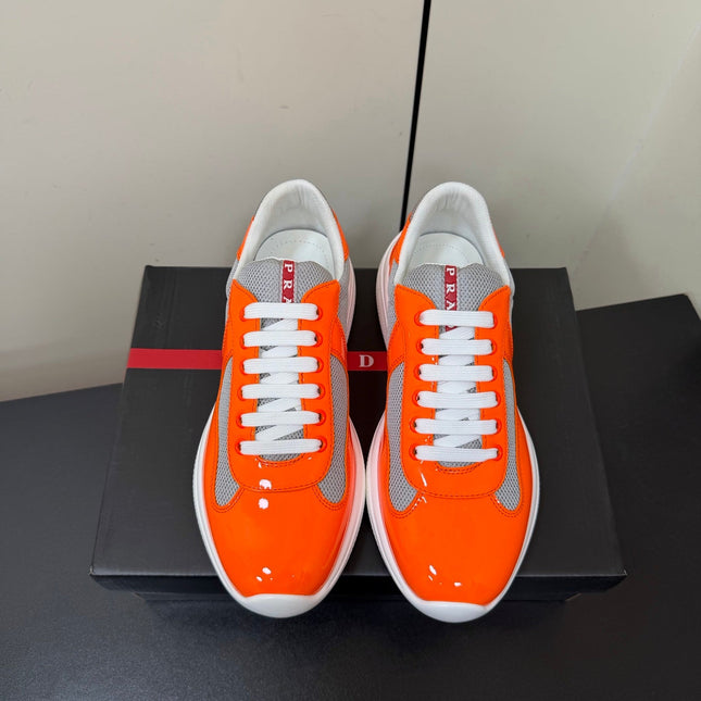 PRADA 26S SNEAKERS IN ORANGE PATENT CALFSKIN AND WHITE MESH