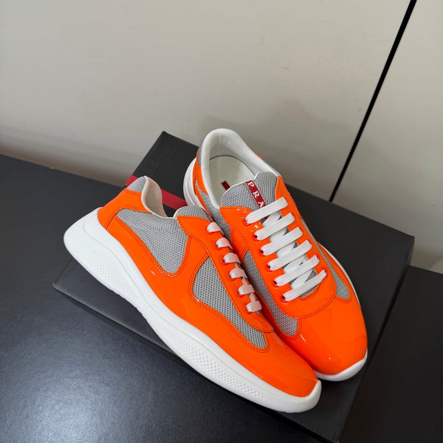 PRADA 26S SNEAKERS IN ORANGE PATENT CALFSKIN AND WHITE MESH