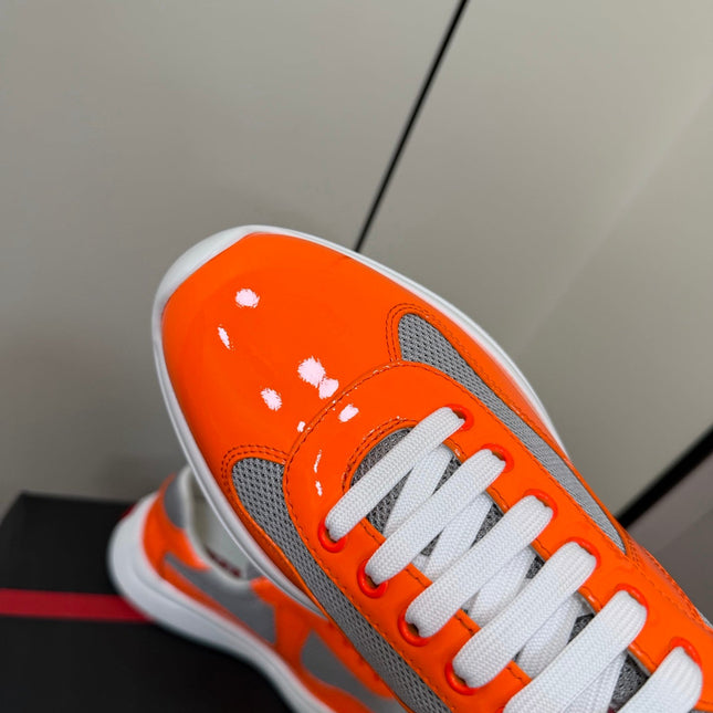 PRADA 26S SNEAKERS IN ORANGE PATENT CALFSKIN AND WHITE MESH