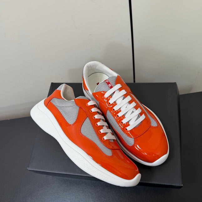 PRADA 26S SNEAKERS IN RED ORANGE PATENT CALFSKIN AND WHITE MESH