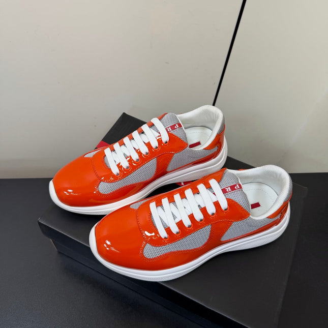 PRADA 26S SNEAKERS IN RED ORANGE PATENT CALFSKIN AND WHITE MESH