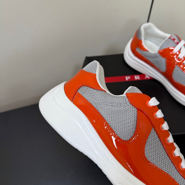 PRADA 26S SNEAKERS IN RED ORANGE PATENT CALFSKIN AND WHITE MESH