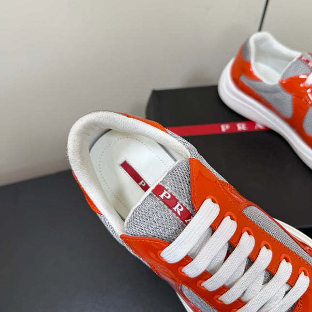PRADA 26S SNEAKERS IN RED ORANGE PATENT CALFSKIN AND WHITE MESH