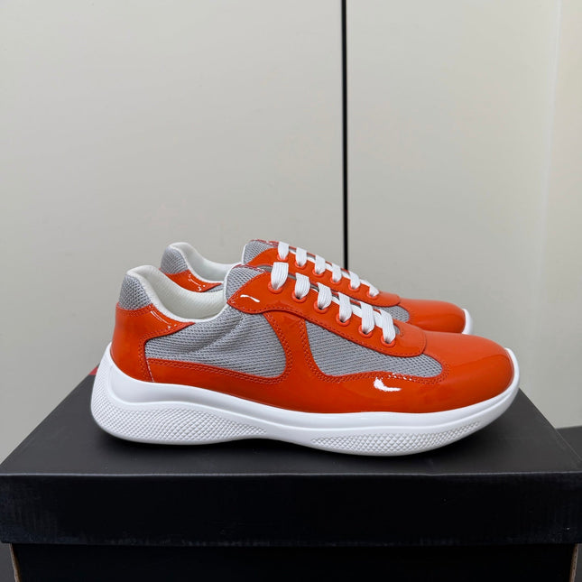PRADA 26S SNEAKERS IN RED ORANGE PATENT CALFSKIN AND WHITE MESH