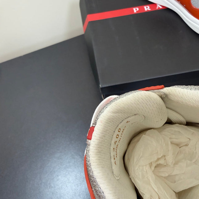 PRADA 26S SNEAKERS IN RED ORANGE PATENT CALFSKIN AND WHITE MESH