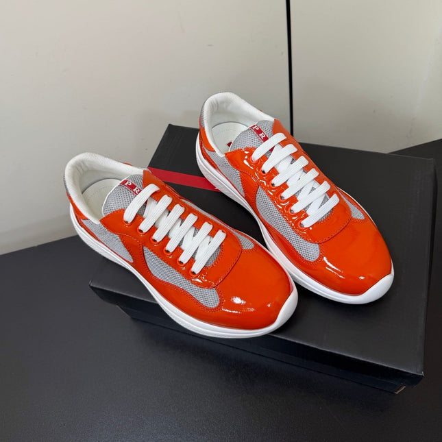 PRADA 26S SNEAKERS IN RED ORANGE PATENT CALFSKIN AND WHITE MESH